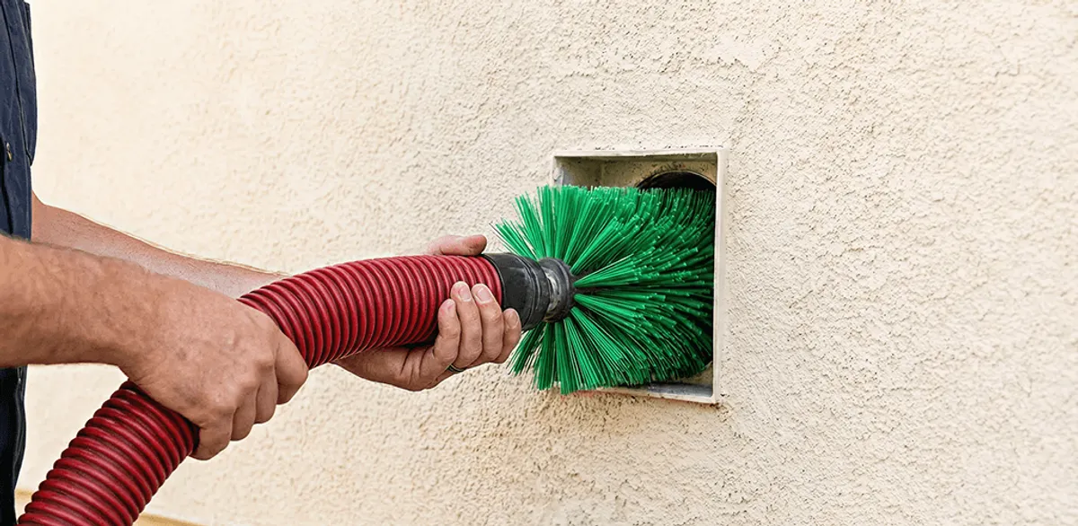 Air duct cleaning brush removing debris from a vent opening in Houston, TX