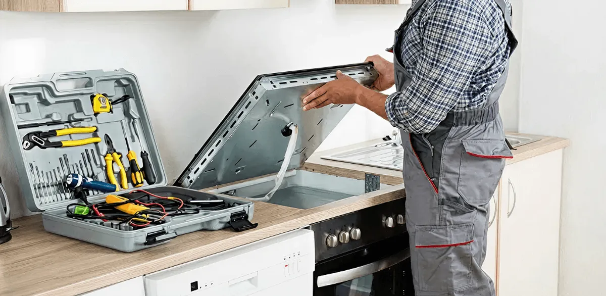 Handyman repairing a cooktop and checking wiring connections in Houston, TX