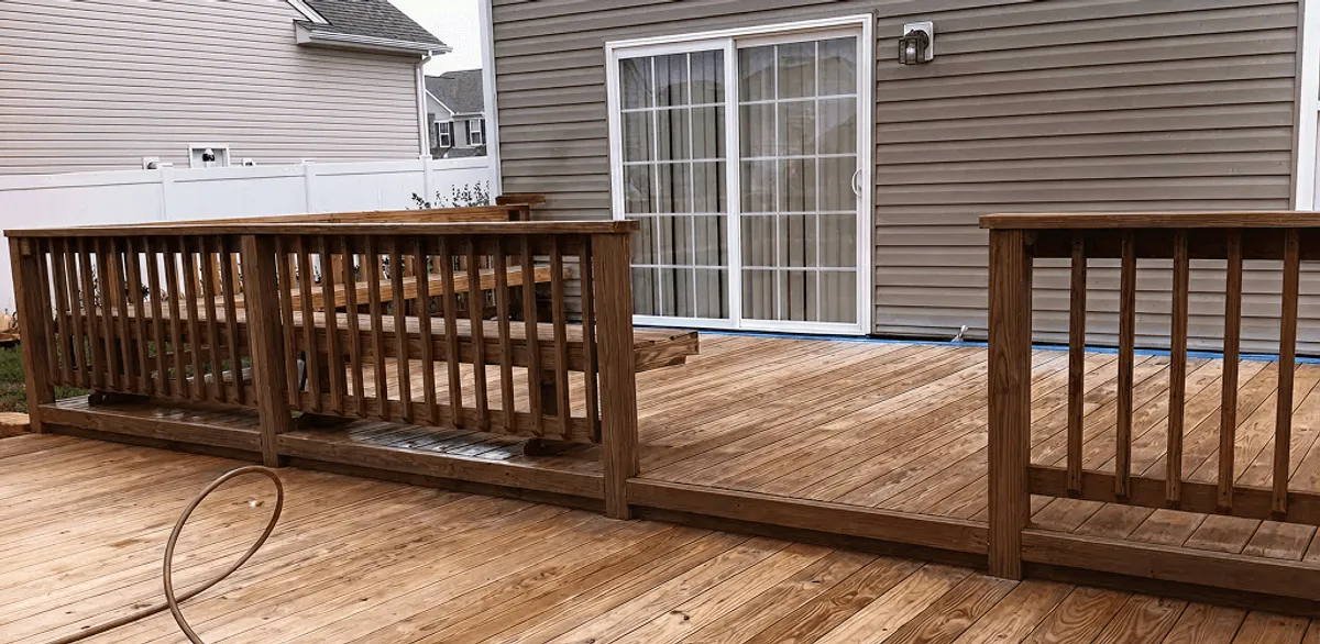 Deck sealing service protecting a backyard wood deck and railings in Houston, TX
