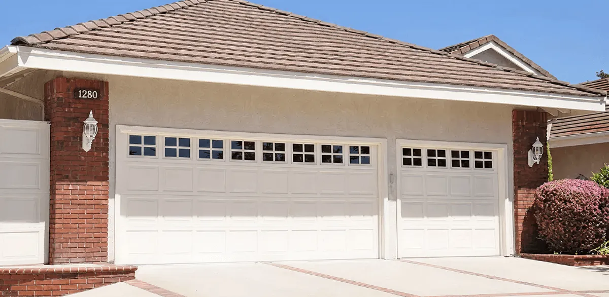 Residential garage door repair service for a double garage door in Houston, TX