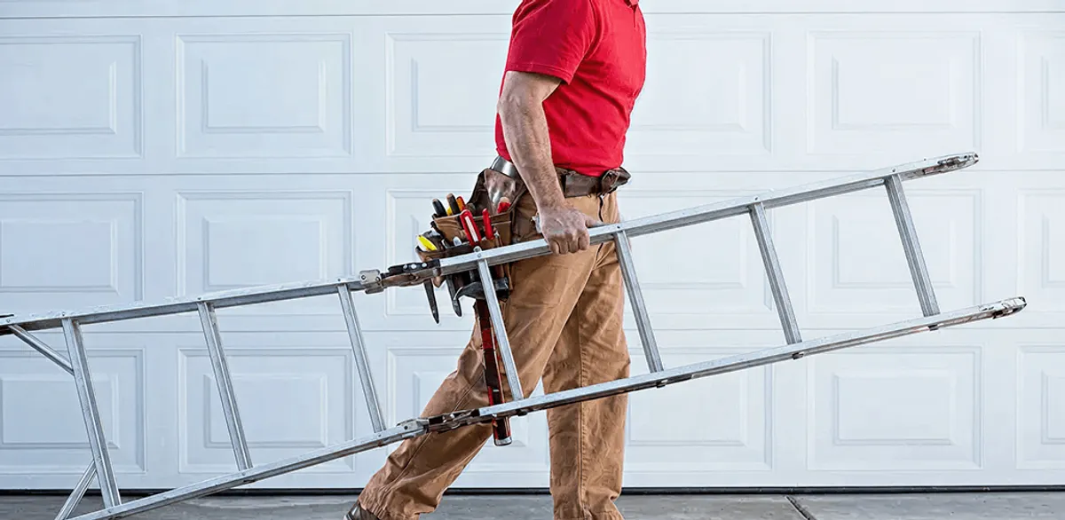 Garage door repair technician arriving with tools and ladder in Houston, TX