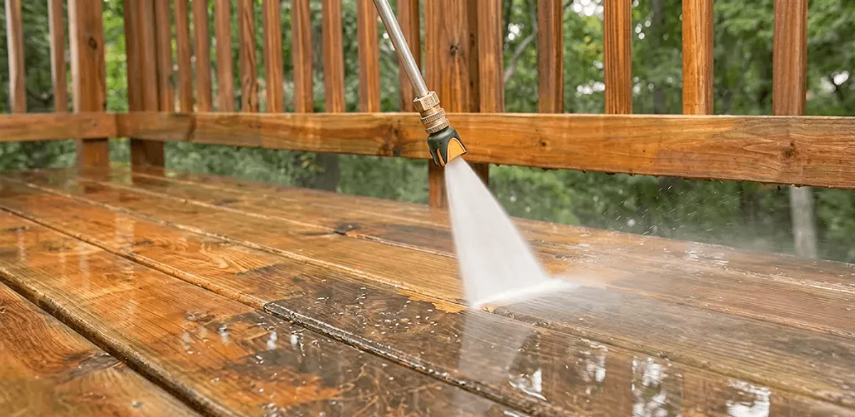 Pressure washing a wood deck to remove dirt and buildup in Houston, TX