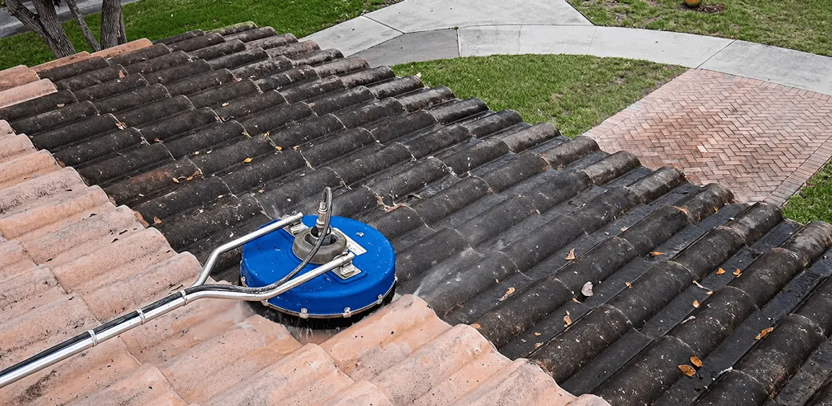 Roof pressure cleaning removing debris and buildup from roof tiles in Houston, TX